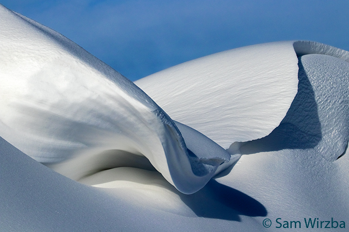 snow drifts take on the appearance of artistic snow scupltures