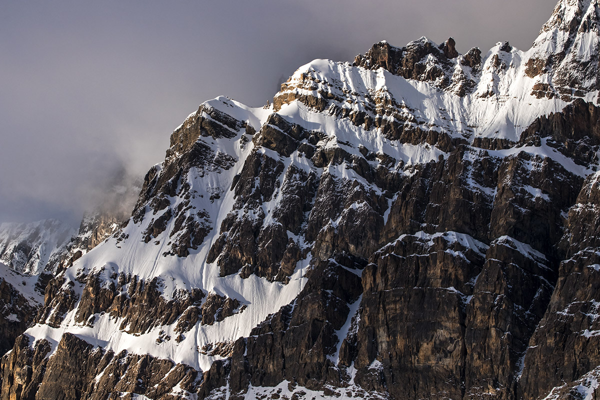 Early light on mountain rock and snow features