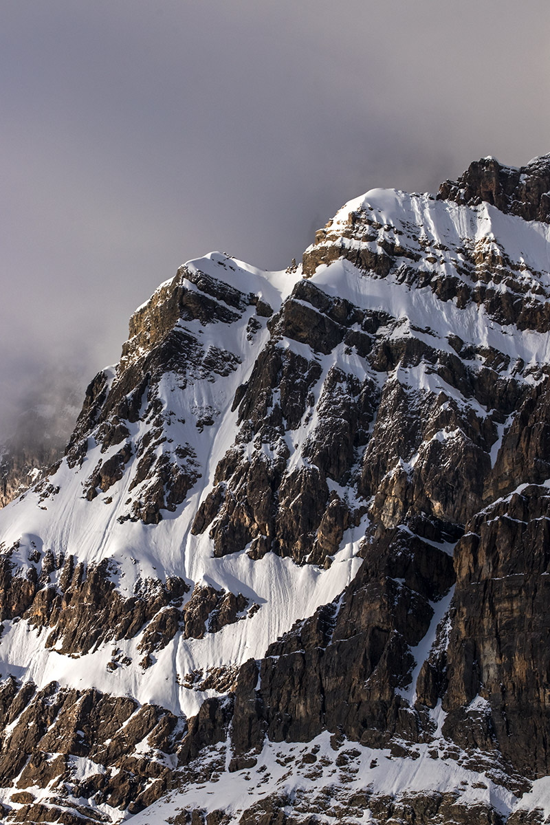 Early light on mountain rock and snow features